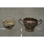 A silver twin handled sugar bowl and a swing handle basket.