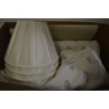 An Oka throw and set of four pleated lamp shades.