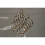 A silver four division trefoil shaped toast rack.