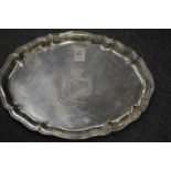 A Continental shaped oval silver salver with engraved armorial.