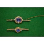 A yellow metal bar brooch set with a blue stone, possibly sapphire, with diamonds, pearls and enamel