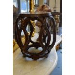 A Chinese hardwood pierced barrel shaped stand.