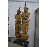 A pair of carved wood Thai standing figures.
