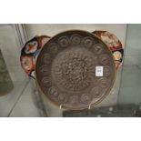 A relief cast classical style bronze circular plaque.