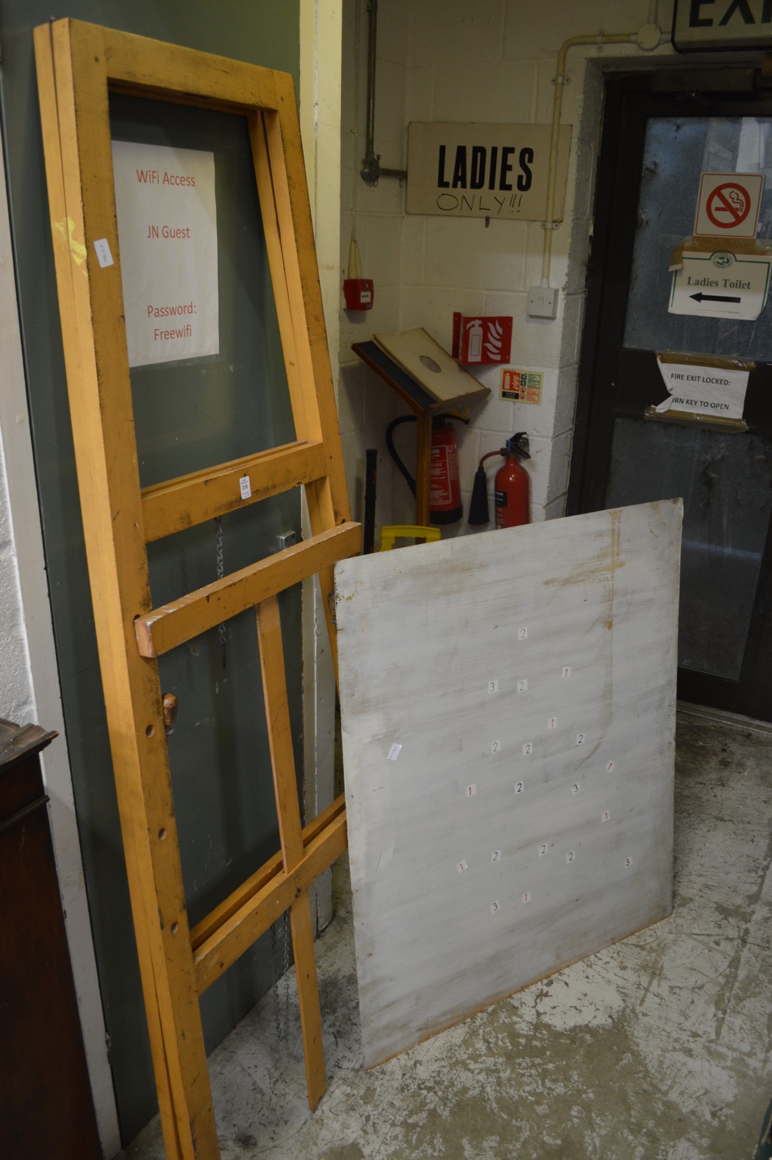 An easel and a large sheet of metal.