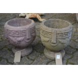 A pair of small composite garden planters.