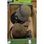 A German military helmet and two other helmets.