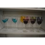Quantity of colourful wine glasses.