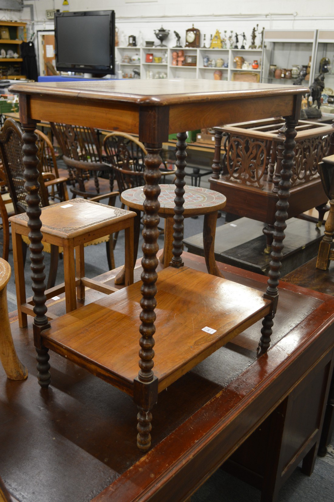 A walnut two tier occasional table.