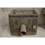 A lead rainwater hopper dated 1800.
