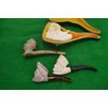 Four various meerschaum pipes.