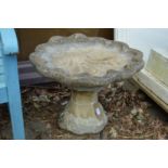 A shell shaped bird bath.