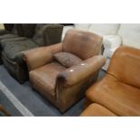 An Italian brown leather upholstered armchair.