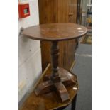 A circular oak occasional table.