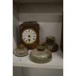 Glass inkwells and a small clock.