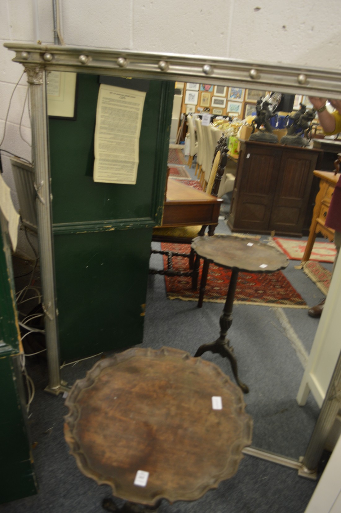 A large Regency style overmantle mirror with silver painted frame.