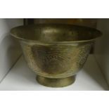 An Eastern engraved brass pedestal bowl.