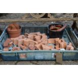 A quantity of terracotta plant pot feet.