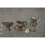 A Continental silver cup and silver with embossed decoration together with a pedestal jug and an