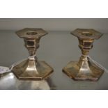 A pair of silver hexagonal shaped candlesticks.