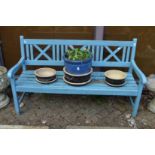 A blue painted garden bench.