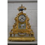 A good French ormolu mantle clock with porcelain panels, the dial signed by the retailer John