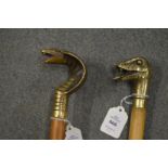 Two walking sticks, the brass handles modelled as snakes heads.