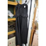 A Ladies black satin full length dress.