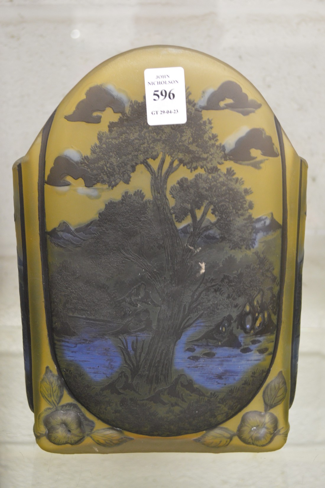 An Art Nouveau style iridescent slab form vase decorated with trees and a pond in a Galle style.