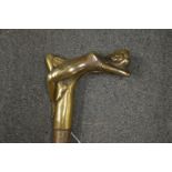 A walking stick, the brass handle modelled as a reclining female figure.