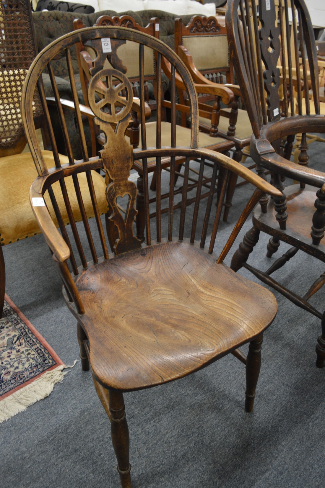 A 19th century ash and elm wheelback Windsor armchair.