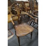 A 19th century ash and elm wheelback Windsor armchair.
