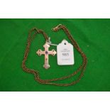 A 9ct gold cross on chain, inset with various gem stones.