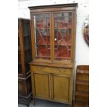 An Edwardian inlaid mahogany cupboard bookcase.