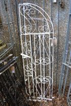 A pair of white painted wrought iron arch topped gates, combined size 156cm high x 82cm wide