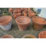 Three large terracotta plant pots.