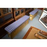 A pair of rustic pine and upholstered long stools.