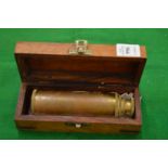 A boxed brass telescope.