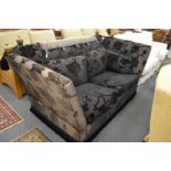 A Knoll large two seater sofa upholstered in a black ground flock decorated fabric.