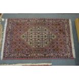 A small Persian rug with stylised decoration.