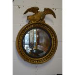 A Regency convex mirror with eagle mount.