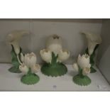 A set of five naturalistically formed flower vases.