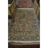 A good Persian rug with floral decoration 180cm x 120cm.