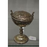 A good Continental silver plated pedestal cup and cover with embossed and applied decoration.