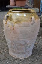 A large Continental part glazed terracotta urn.