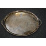 A silver oval twin handled tray with presentation inscription.