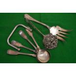 Embossed silver tongs and other items.