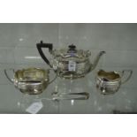 A bachelor's silver three piece tea service of shaped outline with ribbed decoration together with a