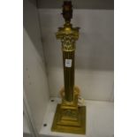 A brass corinthian column table lamp.