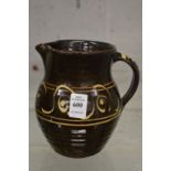 Michael Cardew, Winchcombe Pottery, a slip ware jug with impressed mark.